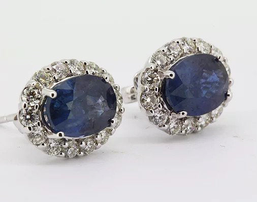 5.35ct Sapphire and Diamond Oval Cluster Earrings; oval faceted sapphires surrounded by 1.20cts brilliant cut diamonds, in 18ct white gold