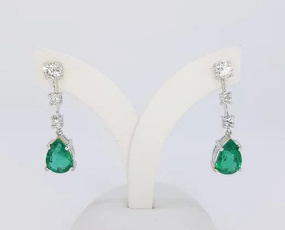 Pear Shaped Emerald and Diamond Drop Earrings; 3.95cts pear-shaped emeralds suspended from 0.89ct graduated diamond drop, 18ct white gold