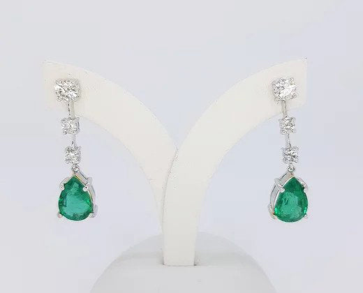 Pear Shaped Emerald and Diamond Drop Earrings; 3.95cts pear-shaped emeralds suspended from 0.89ct graduated diamond drop, 18ct white gold