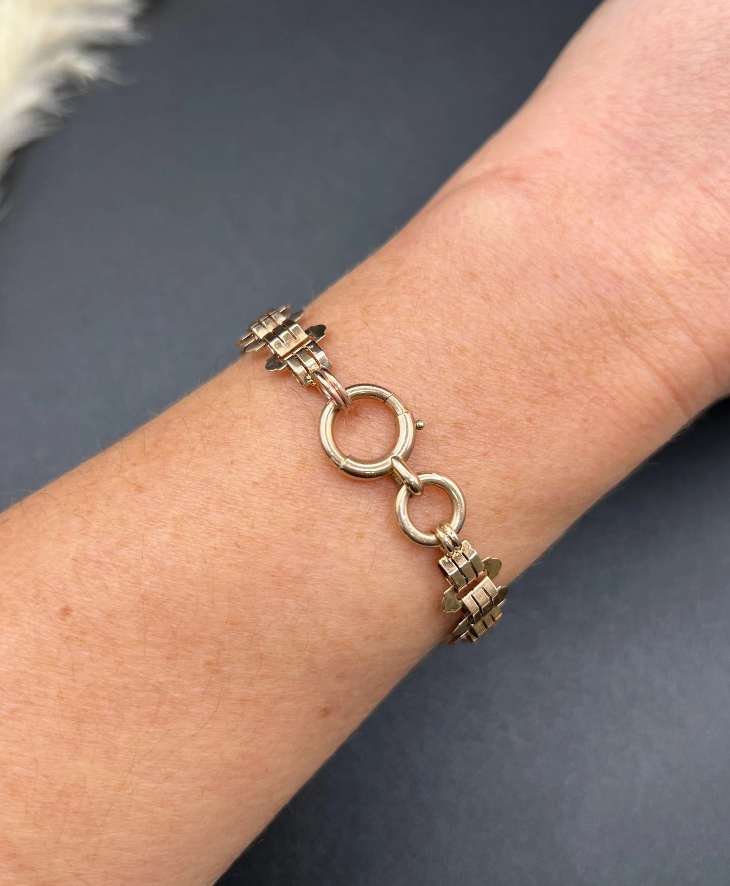 A rose gold fancy link bracelet, modelled on a wrist