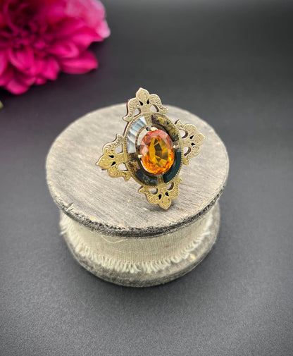 A yellow gold, oval citrine and agate ornate brooch