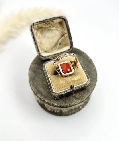 An antique carnelian mourning ring in gold, in a ring box