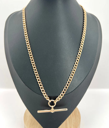 A gold curb link Albert chain, modelled on a black bust