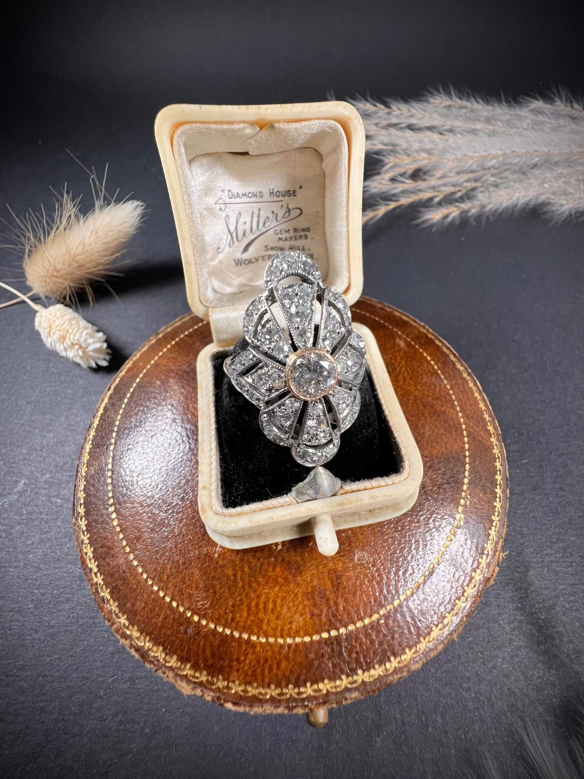 A diamond cocktail ring in white metal, in an antique ring box