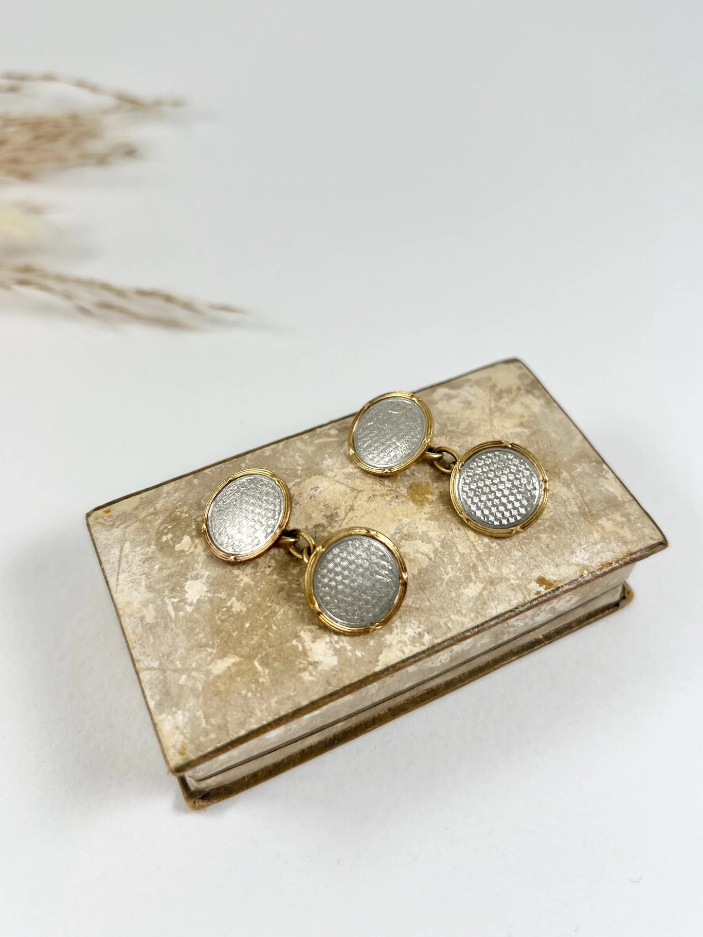 A pair of circular platinum and yellow gold cufflinks