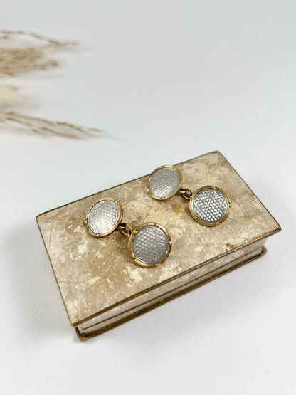 A pair of circular platinum and yellow gold cufflinks