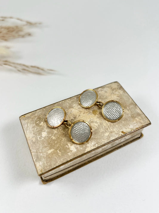 A pair of circular platinum and yellow gold cufflinks