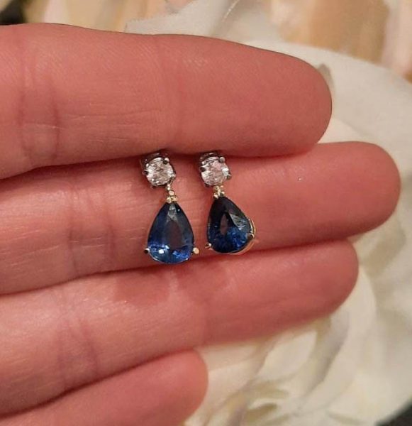 Pear Cut Sapphire and Diamond Drop Earrings; 3.20cts pear-shaped sapphires claw set in yellow gold, suspended from round brilliant-cut diamonds claw set in white gold