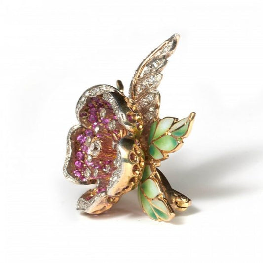 Ruby, Diamond and Plique A Jour Enamel Flower Brooch; pavé set ruby petals accented with old-cut and eight-cut diamonds and with green plique à jour enamel leaves, in silver and gold