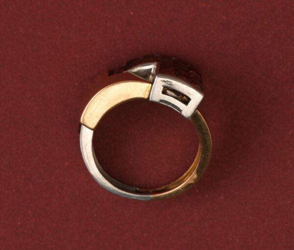 Art Deco Garnet Set Ring; geometrical construct in 18ct gold and platinum, set with 3.60cts square-cut blind-set hessonite garnets. France, Numbered 32827. 