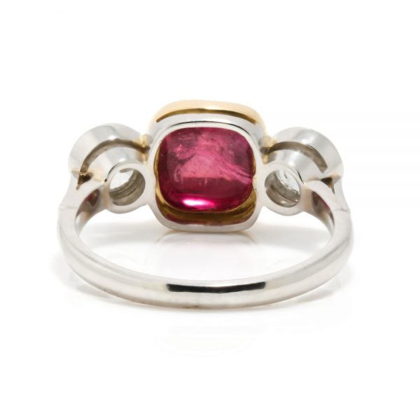 Art Deco Natural Cabochon Ruby and Diamond Trilogy Ring; central 4.52ct cabochon-cut natural ruby flanked by 1cts old-cut diamonds, in 18ct yellow gold and platinum, Circa 1920, with GCS certificate