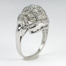 Vintage Diamond and Platinum Domed Cocktail Ring; central dome encrusted with brilliant diamonds, with a curve of tapered baguette diamonds and diamond set shoulders, 3.72 carat total. Numbered 995644