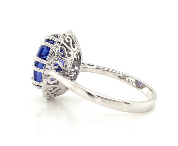 Tanzanite and Diamond Cluster Dress Ring; central 4.56 carat oval faceted tanzanite with brilliant and baguette-cut diamond surround, in 18ct white gold