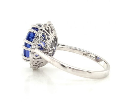Tanzanite and Diamond Cluster Dress Ring; central 4.56 carat oval faceted tanzanite with brilliant and baguette-cut diamond surround, in 18ct white gold