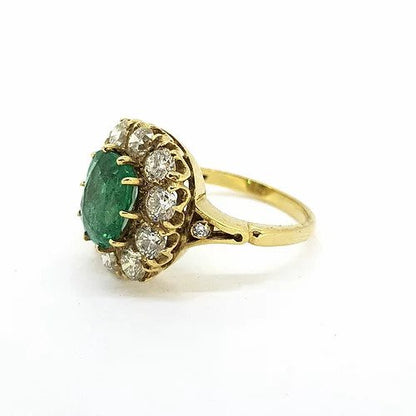 Victorian Style Emerald and Old Cut Diamond Cluster Ring; featuring a central 2.50ct cushion cut emerald surrounded by 2.00cts old-cut diamonds, in 18ct yellow gold