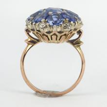 Vintage 8.90ct Sapphire and Diamond Cluster Ring; nine oval sapphires in a floral design, accented with brilliant cut diamonds, in 18ct white and rose gold