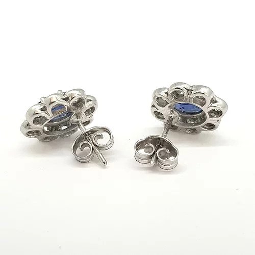 Sapphire and Diamond Cluster Stud Earrings; featuring 2.05cts oval faceted sapphires in a surround of 1.10cts collet set brilliant cut diamonds, in 18ct white gold