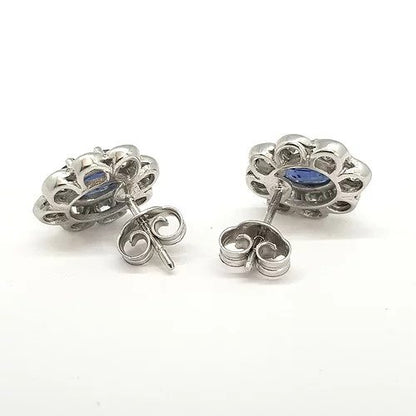 Sapphire and Diamond Cluster Stud Earrings; featuring 2.05cts oval faceted sapphires in a surround of 1.10cts collet set brilliant cut diamonds, in 18ct white gold