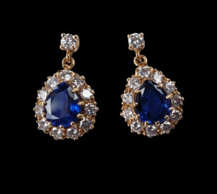 Vintage Sapphire and Diamond Pear Shaped Cluster Drop Earrings; featuring 2.00cts royal blue pear-cut sapphires surrounded by 0.84cts brilliant cut diamonds, with diamond top, in 18ct yellow gold, Circa 1970s