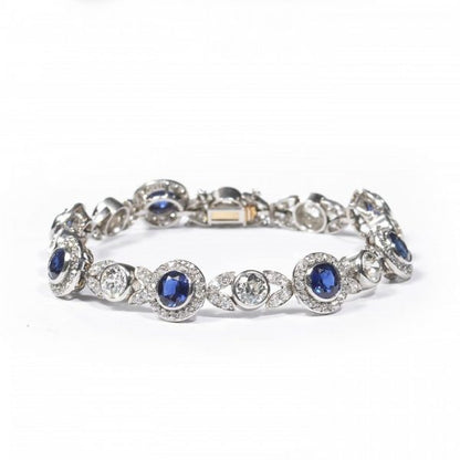 Belle Epoque Burmese Sapphire and Old Cut Diamond Bracelet in Platinum; comprised of round Burmese sapphire and diamond clusters, connected by diamond-set leaf motifs with a round old-cut diamond between each. Circa 1900. Sapphires 5.25 carats, Diamonds 9.50 carats