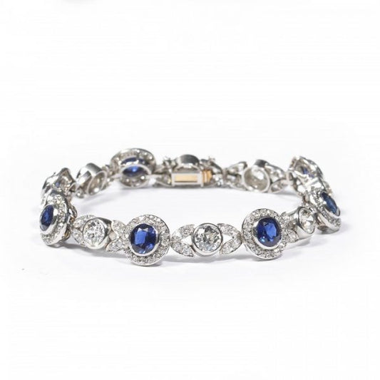 Belle Epoque Burmese Sapphire and Old Cut Diamond Bracelet in Platinum; comprised of round Burmese sapphire and diamond clusters, connected by diamond-set leaf motifs with a round old-cut diamond between each. Circa 1900. Sapphires 5.25 carats, Diamonds 9.50 carats