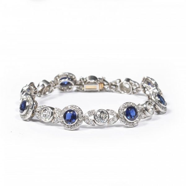 Belle Epoque Burmese Sapphire and Old Cut Diamond Bracelet in Platinum; comprised of round Burmese sapphire and diamond clusters, connected by diamond-set leaf motifs with a round old-cut diamond between each. Circa 1900. Sapphires 5.25 carats, Diamonds 9.50 carats