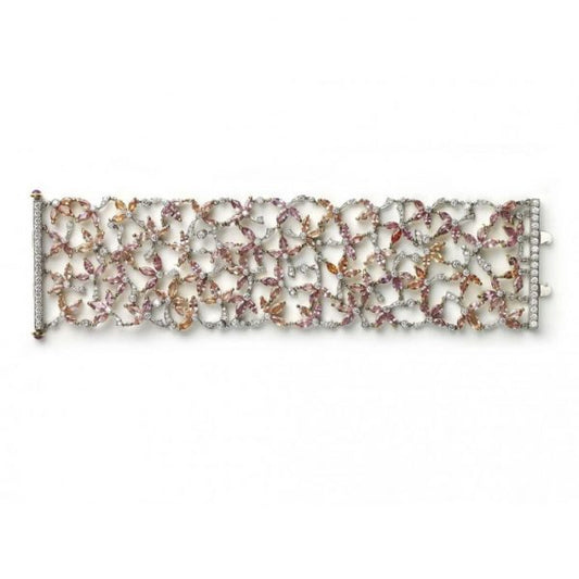 Padparadscha Sapphire, Diamond and Ruby Bracelet; set with 39.52cts pink, orange and red, marquise-cut padparadscha sapphires, decorated with 6.14cts round brilliant-cut diamonds. Accented with cabochon-cut ruby set terminals on the clasp. Mounted in platinum and 18ct yellow gold