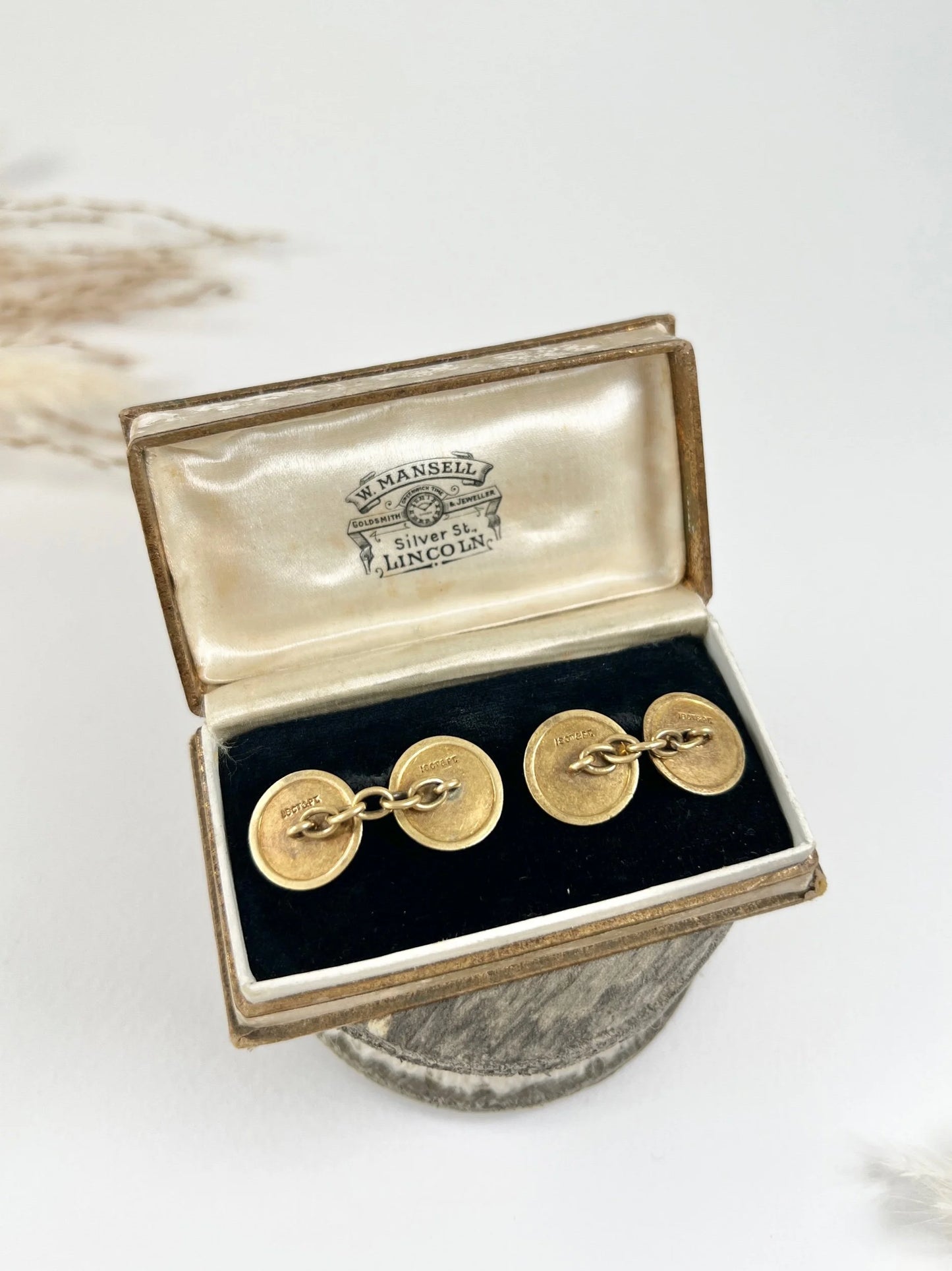 A pair of circular platinum and yellow gold cufflinks, in an antique box
