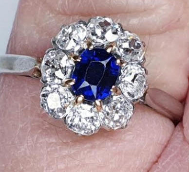 Art Deco Sapphire and Diamond Cluster Engagement Ring; 0.60ct royal blue oval cut sapphire surrounded by 0.80cts old cut diamonds