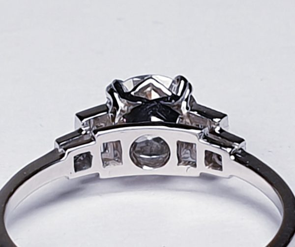 Vintage 1.06ct Old Cut Diamond and Platinum Engagement Ring; featuring a 1.06 carat G colour VS1 clarity old European transitional cut diamond with baguette and radiant-cut diamond shoulders, in platinum