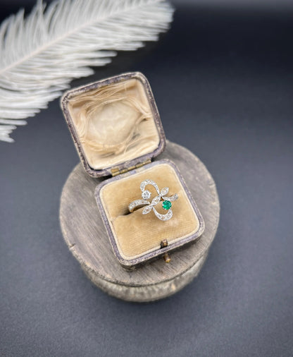 An emerald and diamond fancy openwork ring in yellow gold and platinum, in an antique ring box