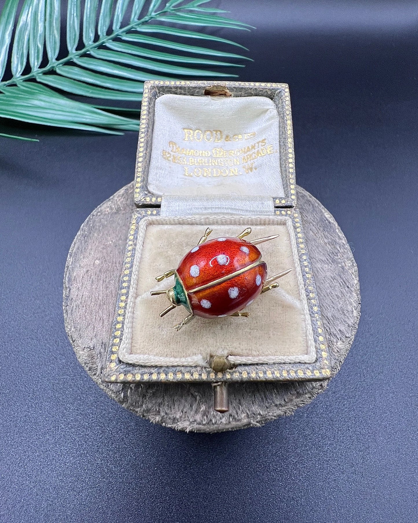 A yellow gold and enamel ladybird brooch