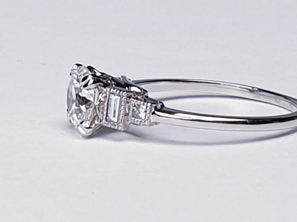 Vintage 1.06ct Old Cut Diamond and Platinum Engagement Ring; featuring a 1.06 carat G colour VS1 clarity old European transitional cut diamond with baguette and radiant-cut diamond shoulders, in platinum