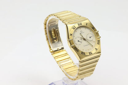 Omega Constellation Day Date 18ct Yellow Gold 33mm Quartz Watch, white dial with weekday and date sub-dials, black Roman numerals, yellow gold bezel, 18ct yellow gold bracelet with matching 18ct push-button clasp.