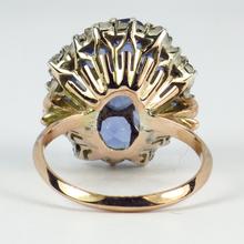 Vintage 8.90ct Sapphire and Diamond Cluster Ring; nine oval sapphires in a floral design, accented with brilliant cut diamonds, in 18ct white and rose gold