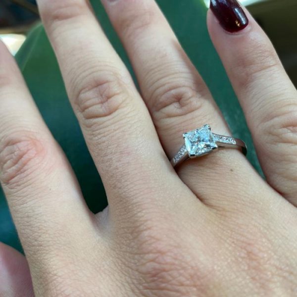 A diamond engagement ring, set with a 1.03 carat, F colour, VS1 clarity, princess-cut diamond, diamond set shoulders, in platinum, with GIA certificate.