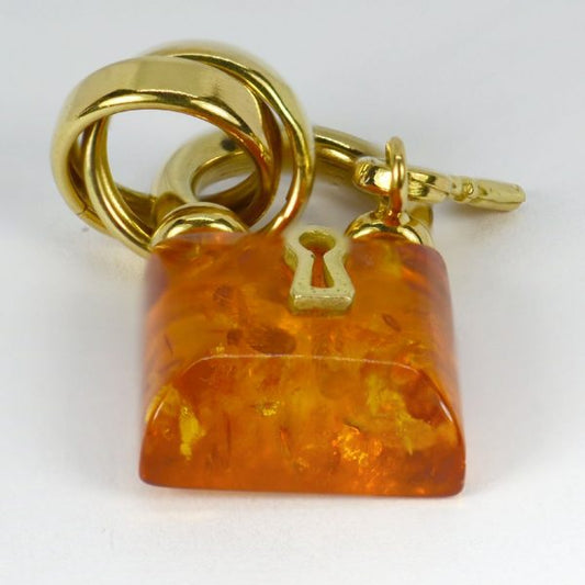 Amber and 18ct Gold Padlock Charm Pendant; French 18ct yellow gold and clarified amber charm pendant designed as a padlock with key