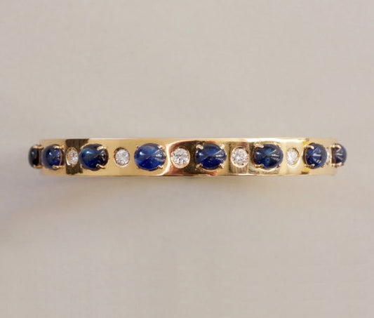 Vintage Sapphire, Diamond and 18ct Yellow Gold Bangle Bracelet; set with 7.00cts oval cabochon sapphires and 0.42cts brilliant cut diamonds