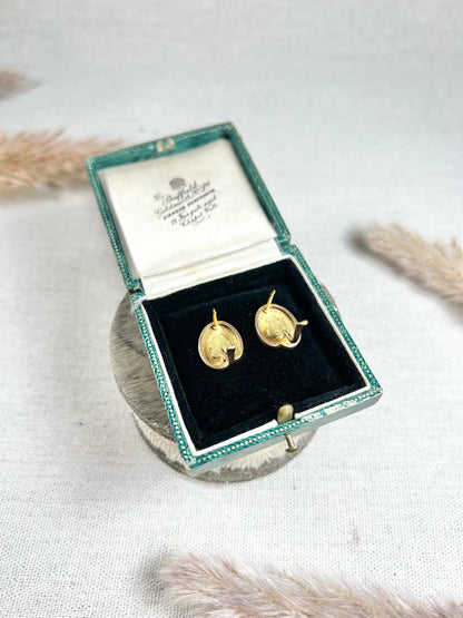 A pair of art palette shaped gold earrings, in a box