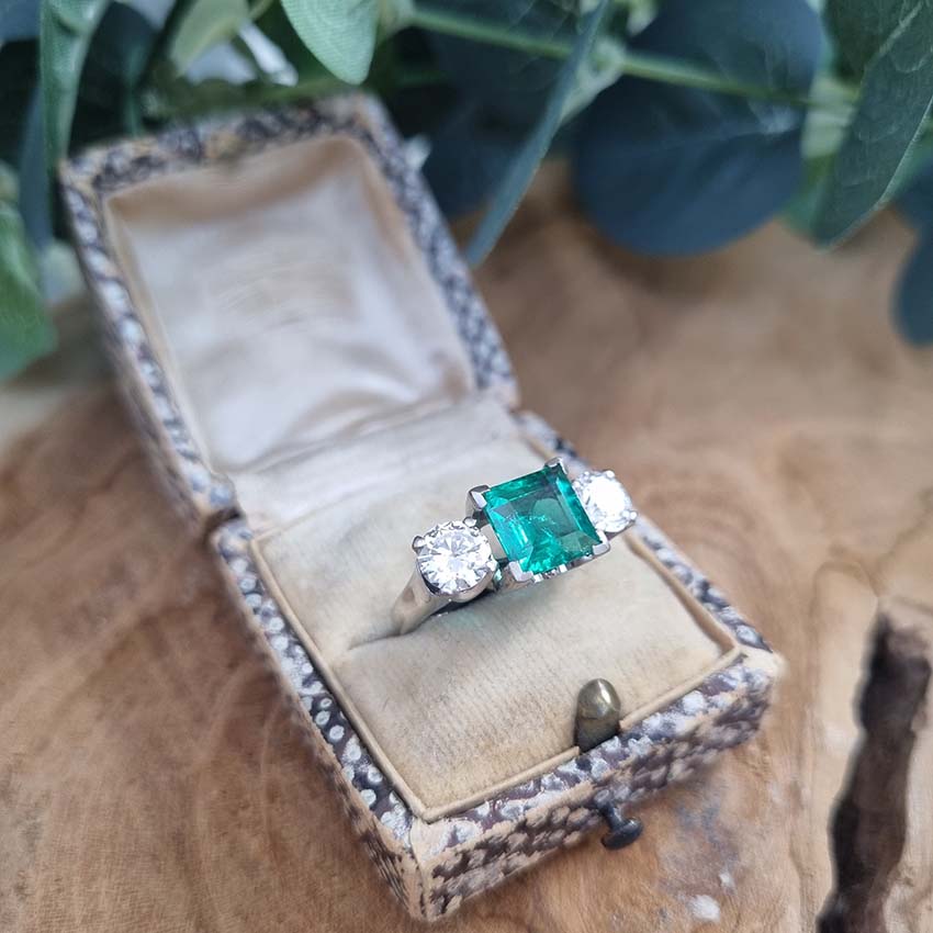 Emerald engagement ring Colombia three stone platinum round