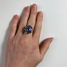 Vintage 8.90ct Sapphire and Diamond Cluster Ring; nine oval sapphires in a floral design, accented with brilliant cut diamonds, in 18ct white and rose gold