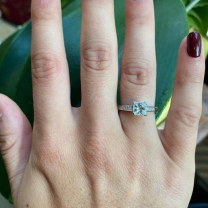 A diamond engagement ring, set with a 1.03 carat, F colour, VS1 clarity, princess-cut diamond, diamond set shoulders, in platinum, with GIA certificate.