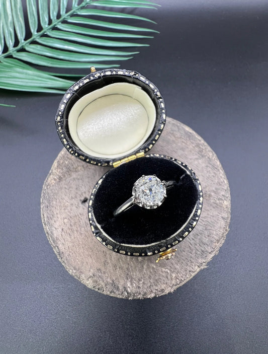 A white gold and platinum solitaire diamond ring, in a ring box