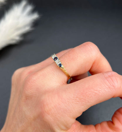 A yellow gold five stone sapphire and diamond carved half hoop ring, modelled on a hand