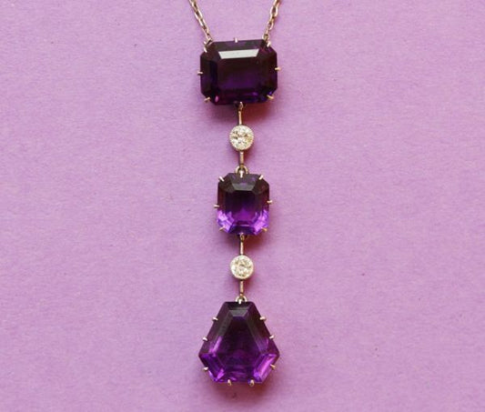 Antique Edwardian 8ct Amethyst and Diamond Drop Pendant; comprising emerald-cut and kite-shaped step-cut amethysts, and old cut diamonds
