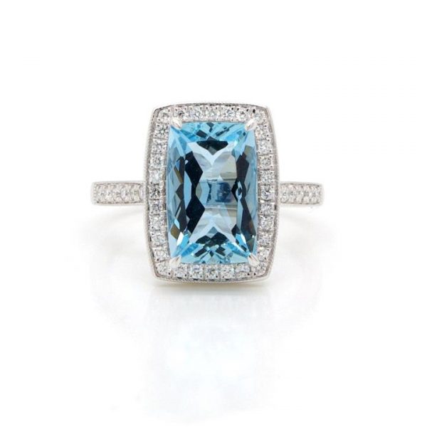 Aquamarine and Diamond Rectangular Cluster Ring; 2.63 carat cushion shaped aquamarine surrounded by diamonds, with diamond shoulders, in 18ct white gold