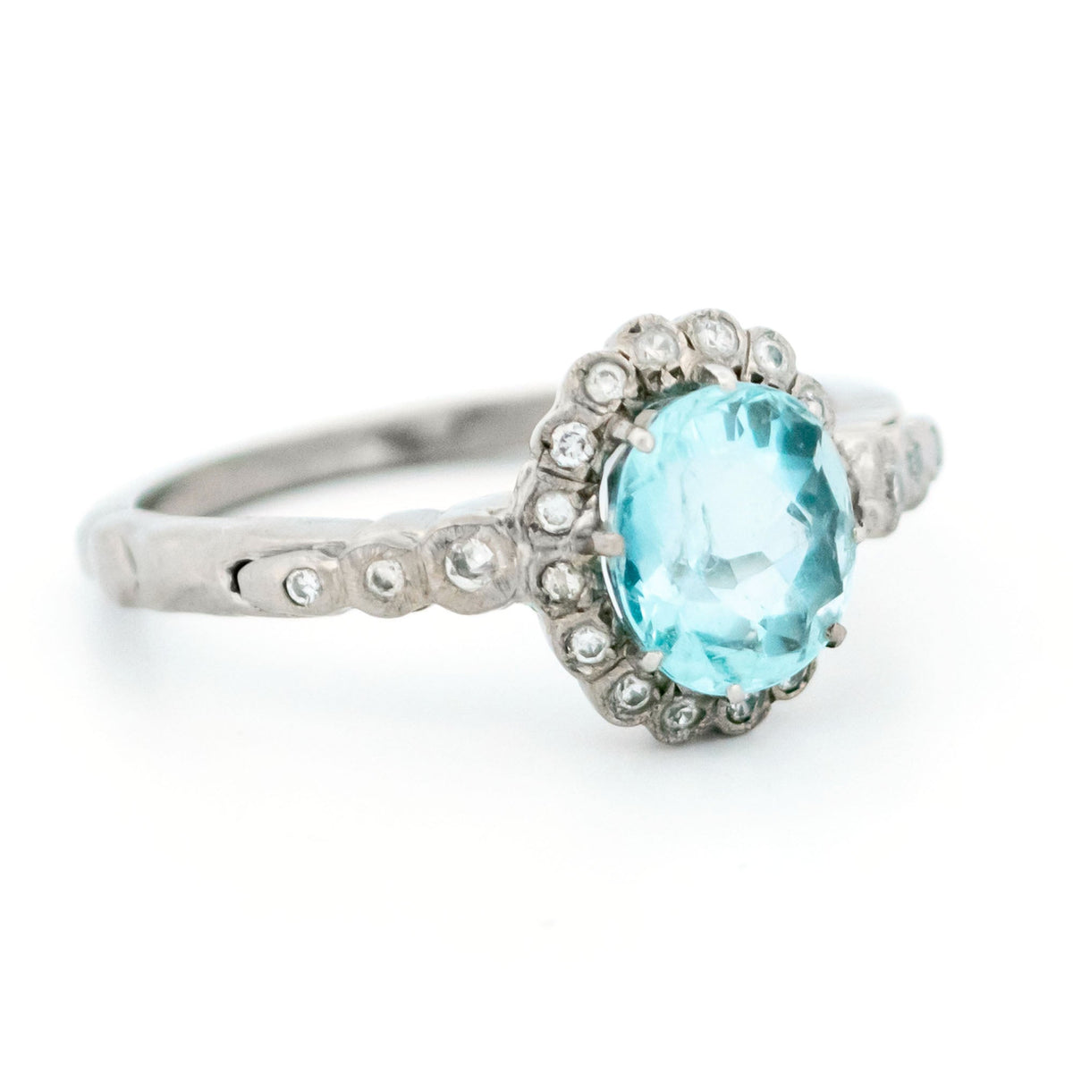 An oval aquamarine and round diamond cluster ring in white gold