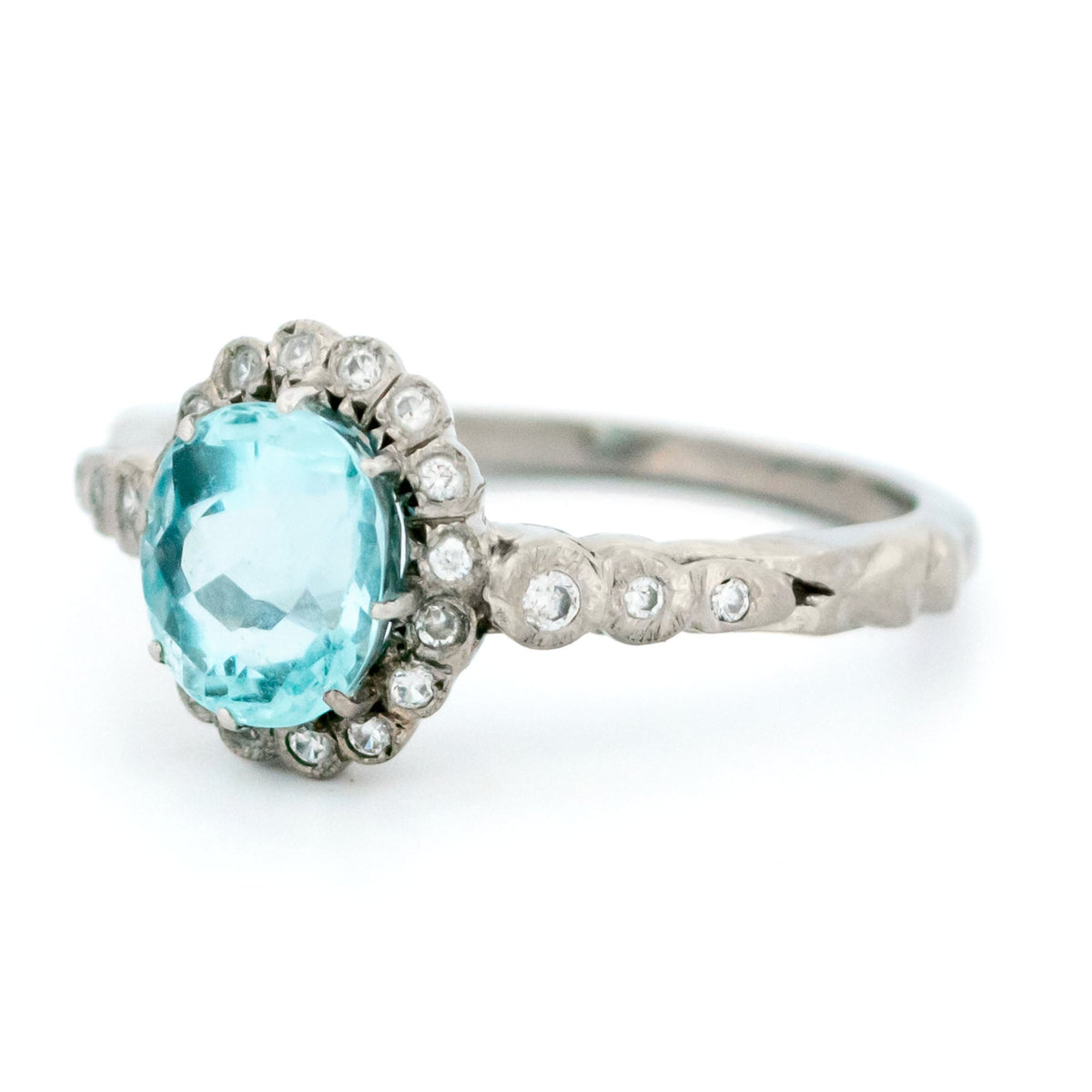 An oval aquamarine and round diamond cluster ring in white gold