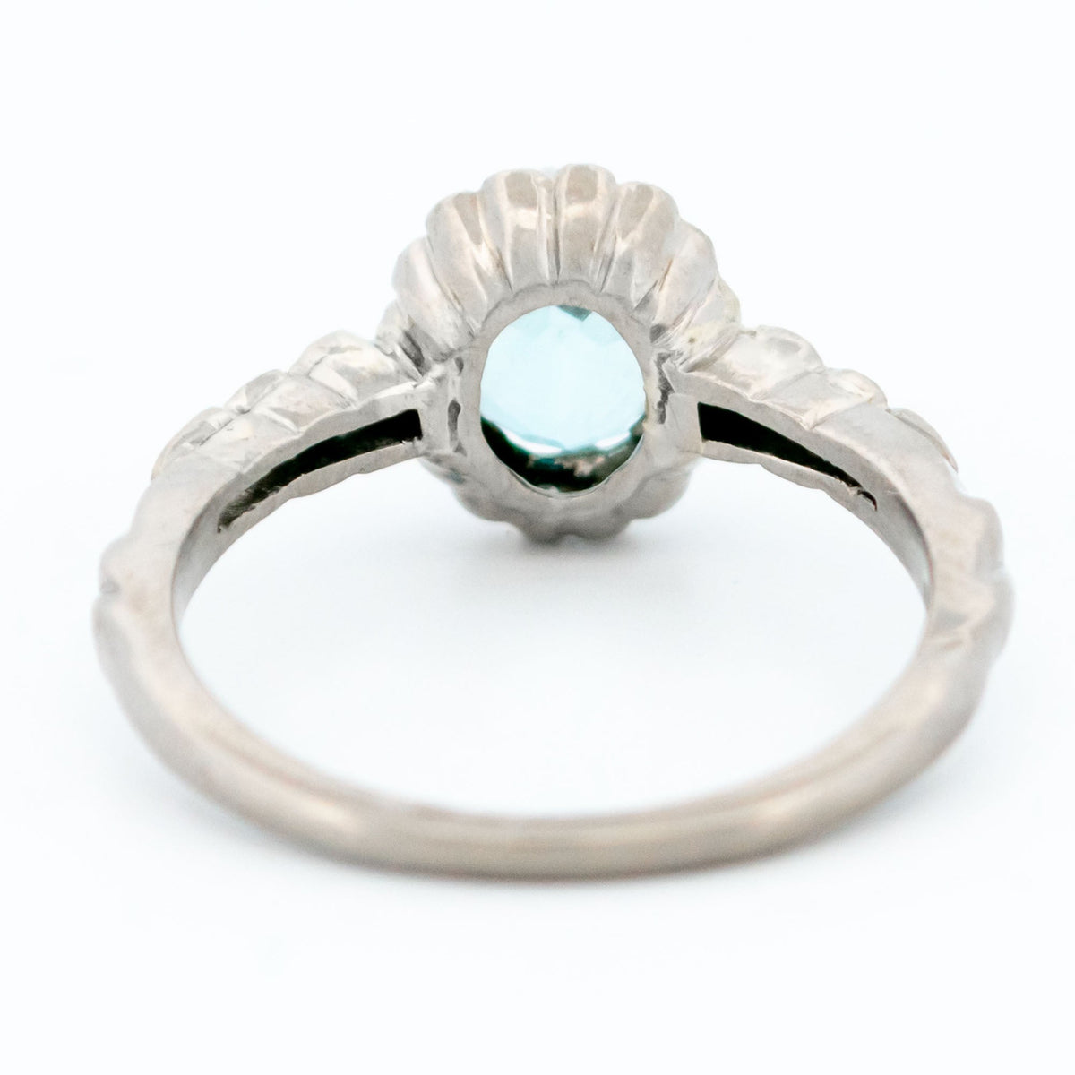 An oval aquamarine and round diamond cluster ring in white gold