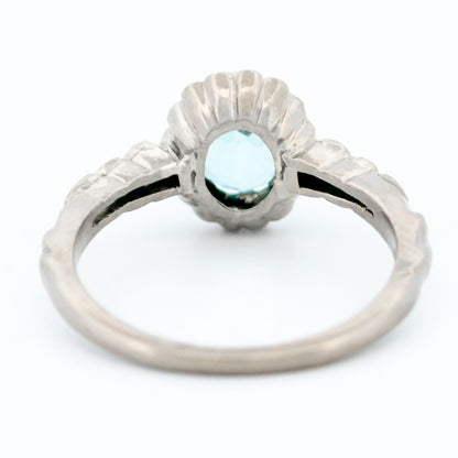 An oval aquamarine and round diamond cluster ring in white gold